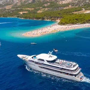 Golden Horn beach (Zlatni Rat) in Bol, island Brač, Croatia, with luxury yacht Mama Marija II and turquoise waters, a renowned destination for travelers worldwide.