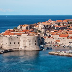 View of Dubrovnik city walls and harbor with the Adriatic Sea in the background