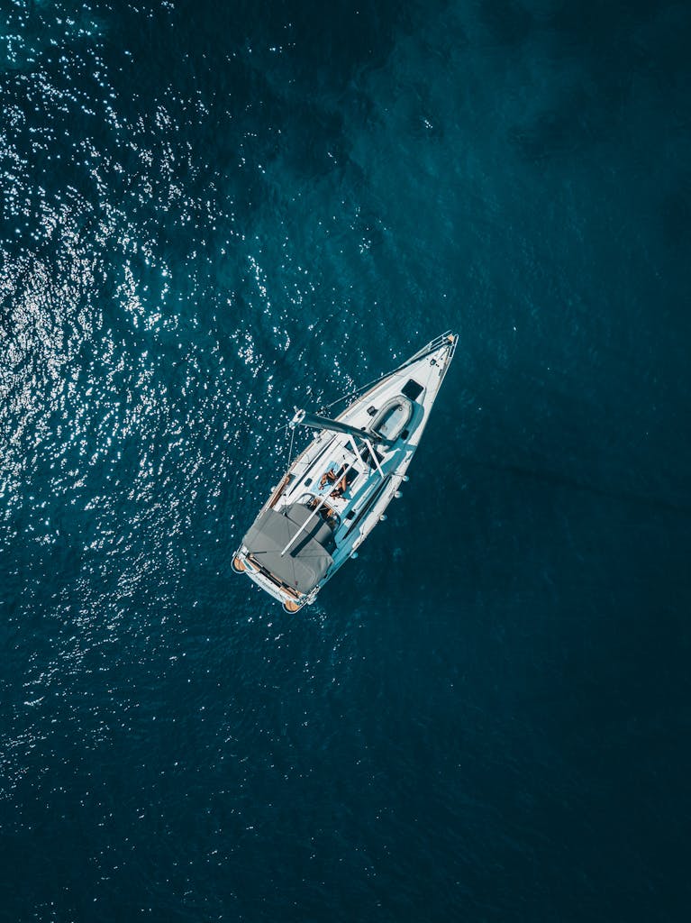 A stunning aerial shot of a sailboat cruising the deep blue waters of Croatia.