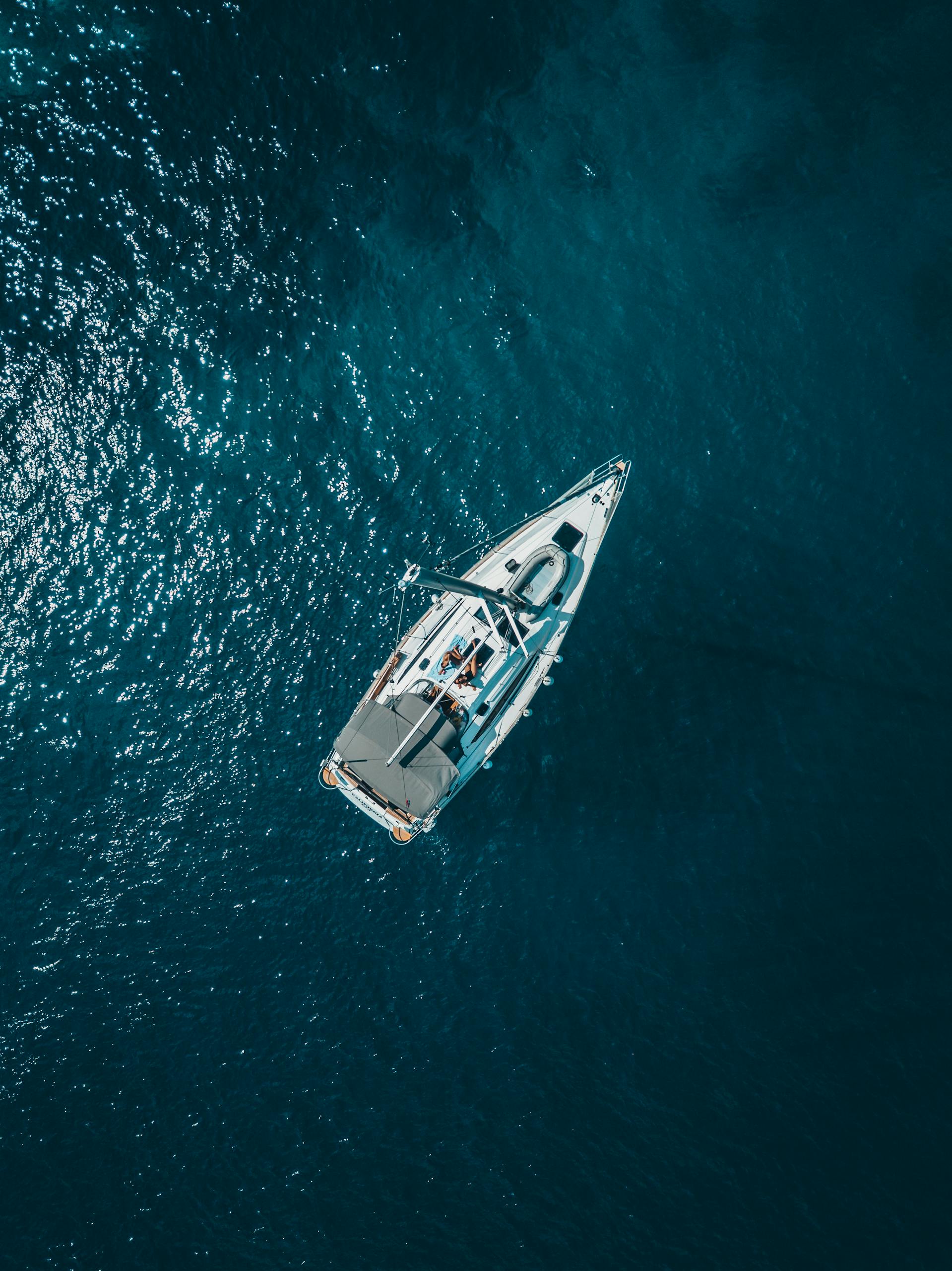 A stunning aerial shot of a sailboat cruising the deep blue waters of Croatia.