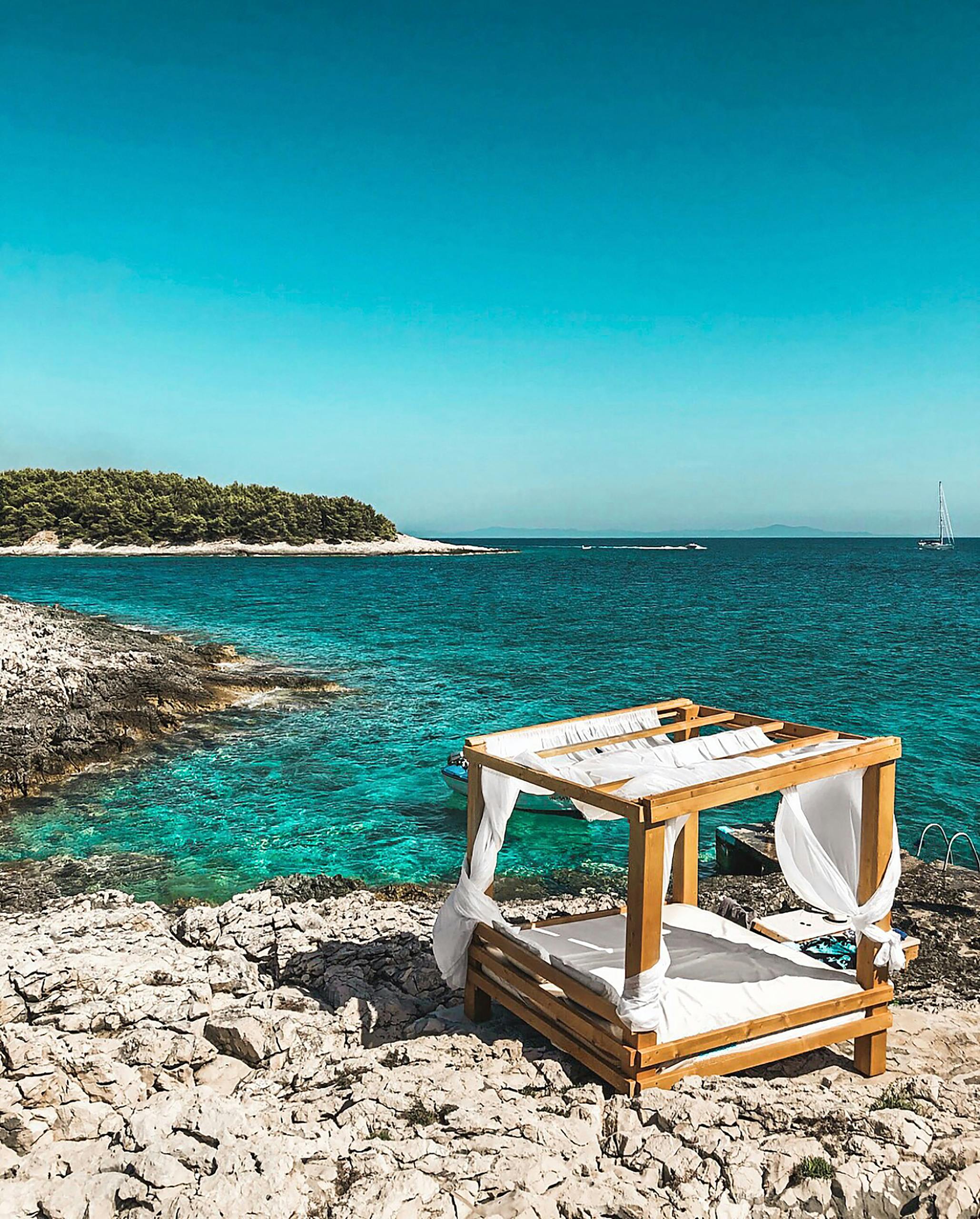 Idyllic cabana by turquoise waters in Split-Dalmatia, Croatia, perfect for relaxation.